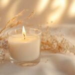 Burning candle on beige background. Aesthetic muted composition dry flowers, textile